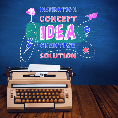 A printer with paper against blue chalkboardの写真素材