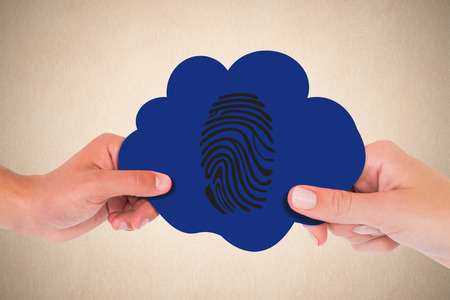 Hand holding cloud against a beige wallの写真素材