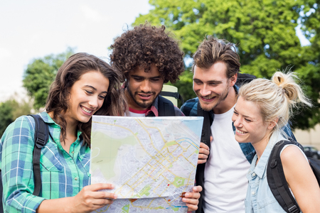 Group of friends looking at mapの写真素材