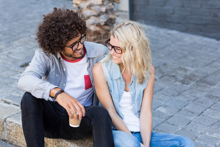 Happy young couple in spectacles interacting with each otherの写真素材