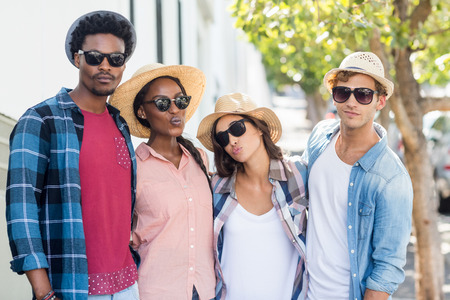Group of friends in sunglasses posing at cameraの写真素材