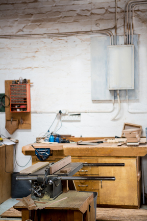 Tools and equipment used for carpentry in a dusty workshopの写真素材