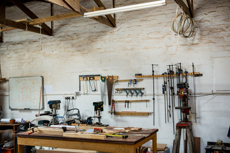 Tools and equipment used for carpentry in a dusty workshop