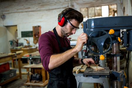 Carpenter working on his craft in a dusty workshop
