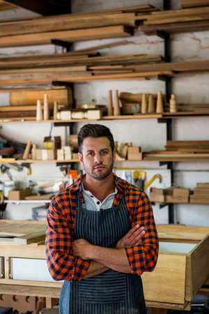 Carpenter crossing arms in his workshopの写真素材