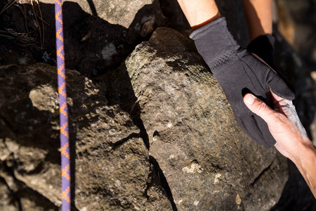 Close up two people helping in rock climbingの写真素材