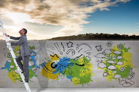 Businessman climbing up ladder against cloudy sky over countrysideの写真素材