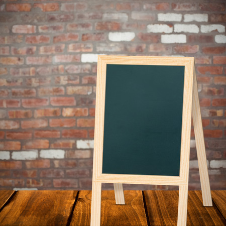 A board in a white background against brick wallの写真素材