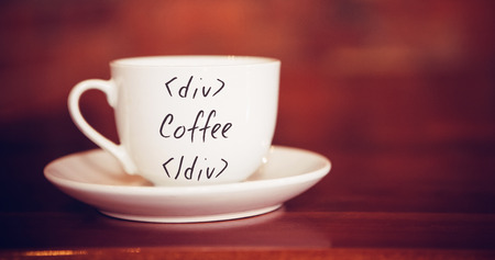 Sentence against cup and saucer on table in cafeの写真素材