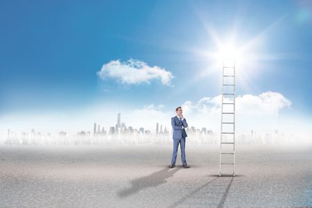 Thinking businessman against cityscape on the horizonの写真素材