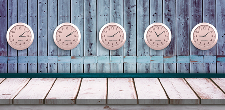 Five pink clock against wooden backgroundの写真素材