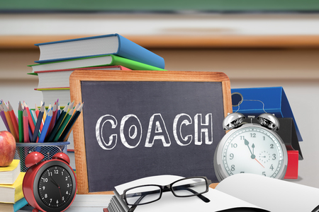 Coach word against red apple on pile of books in classroomの写真素材