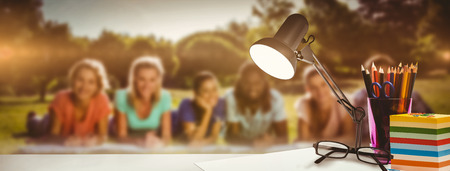 desk against students studying outside on campus