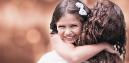 Glowing background against happy mother and daughter smiling at cameraの写真素材
