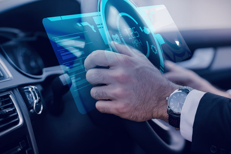 A watch against businessman in the drivers seat