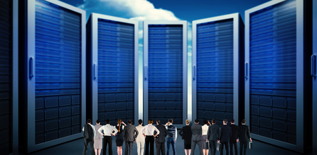 Rear view of multiethnic business people standing side by side against composite image of server...