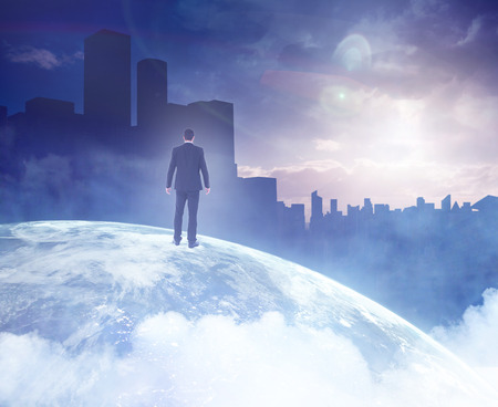 Rear view of businessman standing on a picture of the earthの写真素材