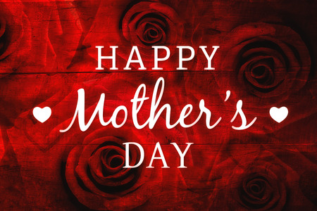 Happy mothers day message with roses on wooden backgroundの写真素材