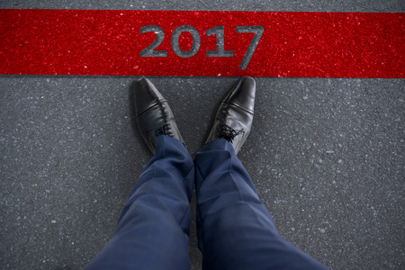 Businessman standing isolated on white background against a roadの写真素材