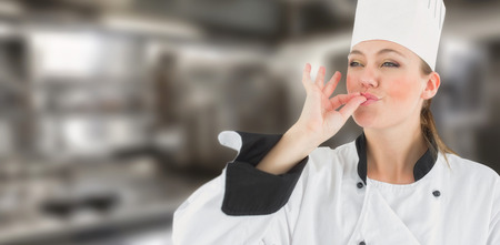 Portrait of a woman chef satisfying against a cookerの写真素材