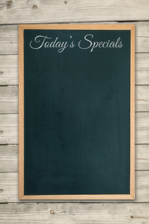 Composite image of restaurant board menu on a wooden deskの写真素材