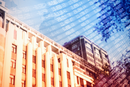 Low angle view of city building against stocks and shares