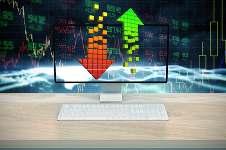 A computer over a deskagainst stocks and shares