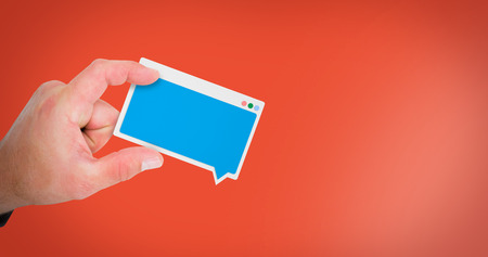 Hand presenting against red backgroundの写真素材