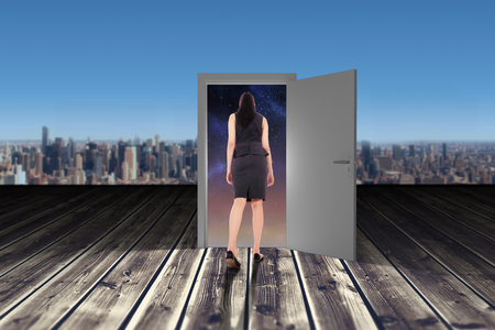 Asian businesswoman walking against wooden planksの写真素材