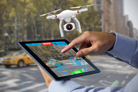Man using tablet pc  against view of a city