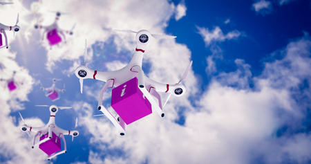 A drone bringing a pink cube against bright blue sky with cloudsの写真素材