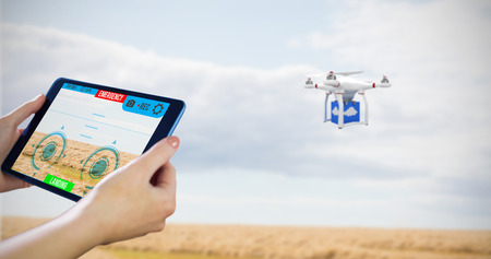 Hands holding tablet against landscape