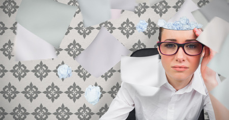 Thinking businesswoman against grey wallpaperの写真素材