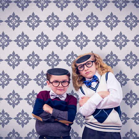 Cute pupils looking at camera against grey wallpaperの写真素材