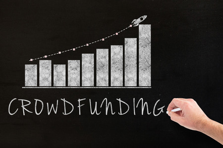 Hand writing with chalk against blackの写真素材