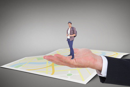 Portrait of happy man holding camera against city mapの写真素材