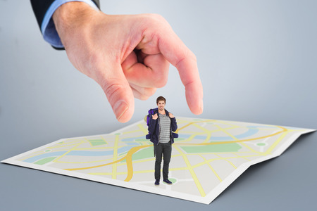 Portrait of happy man with backpack against city mapの写真素材