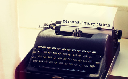 Personal injury claims message on a white background against typewriter on a tableの写真素材