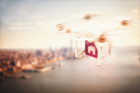 Digital image of a drone holding a cube against city by the seaの写真素材