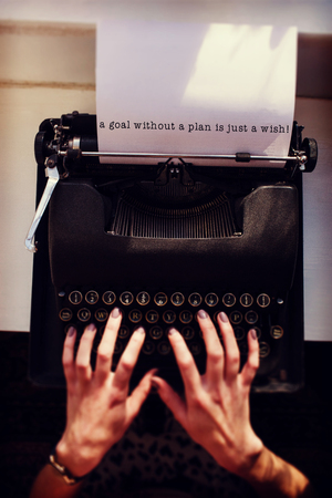 A goal without a plan is just a wish message on a white background  against womans hand typing on...