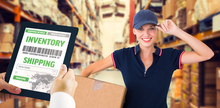 Man using tablet pc against shelves with boxes in warehouse