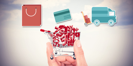 Digital shopping diagram on a white background against composite image of hand showing houseの写真素材