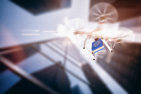 Digital image of a drone holding a cube against skyscraperの写真素材
