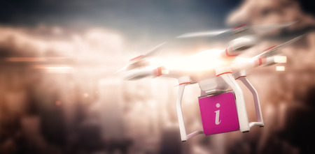 Digital image of a drone holding a cube against aerial view of a city on a cloudy day