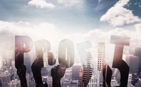 Hands holding up profit  against aerial view of a city on a cloudy dayの写真素材