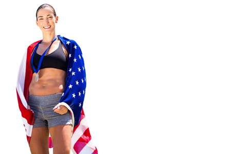 Sporty woman posing and smiling with American flagの写真素材