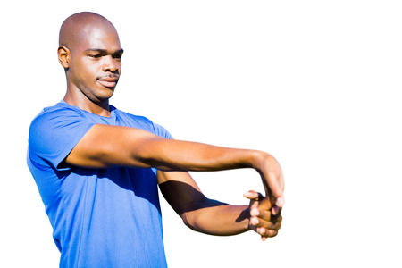 Portrait of sportsman is stretching his muscles
