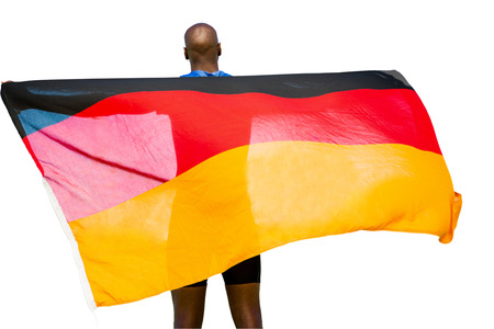 Rear view of sportsman is holding a german flagの写真素材