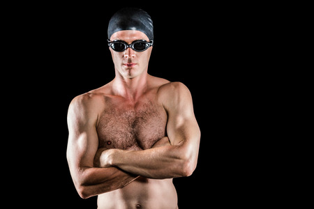 Swimmer posing with arms crossed on black backgroundの写真素材