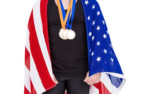 Athlete with a gold medal holding american flag on white backgroundの写真素材